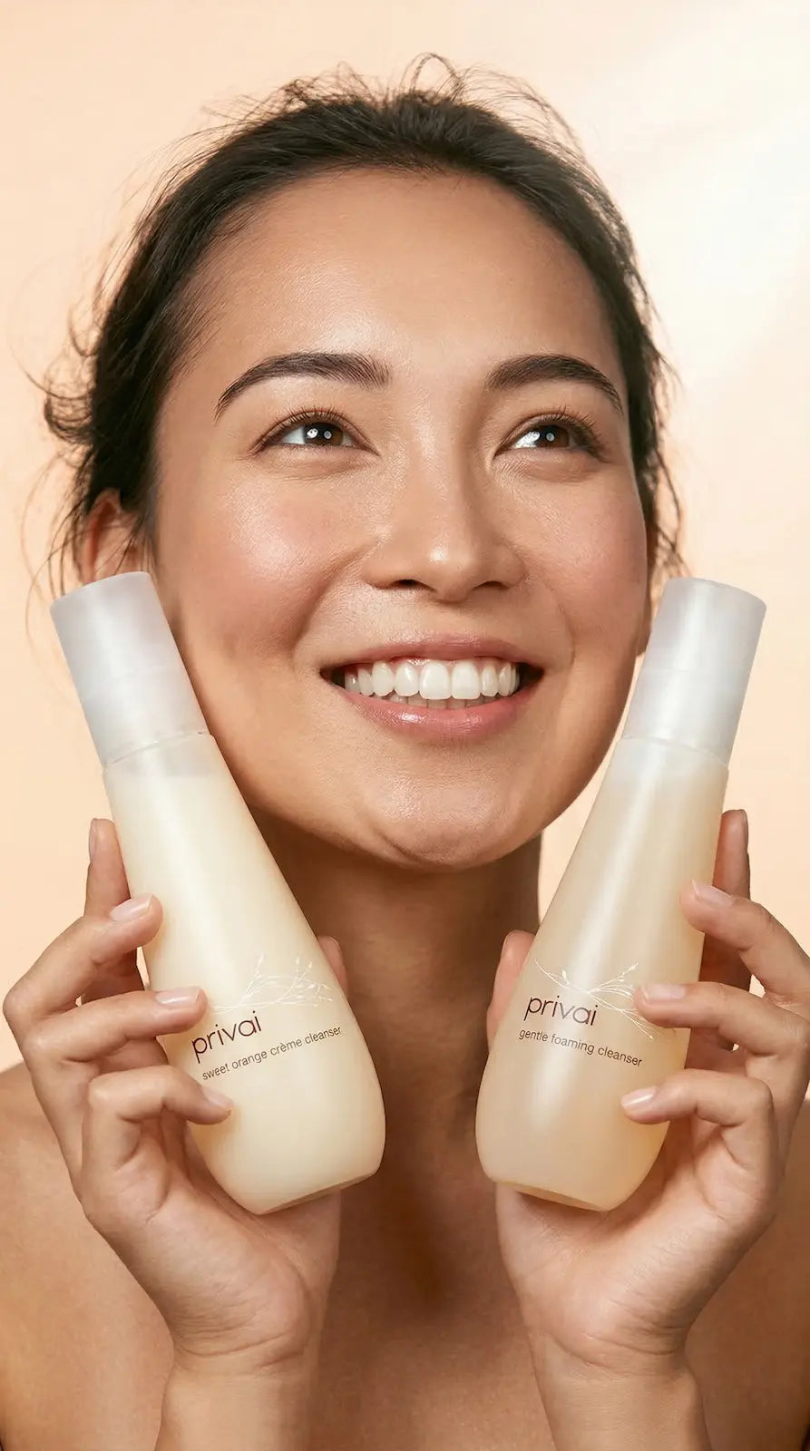 WOman holding two cleansing skin care products