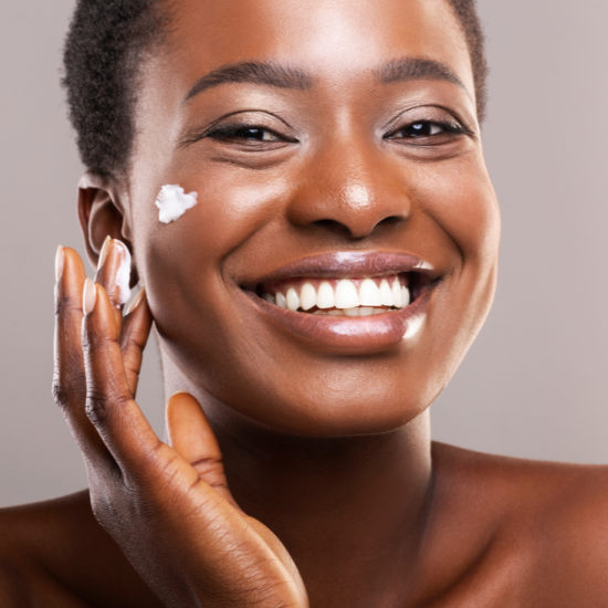 African American Woman with skincare on her face